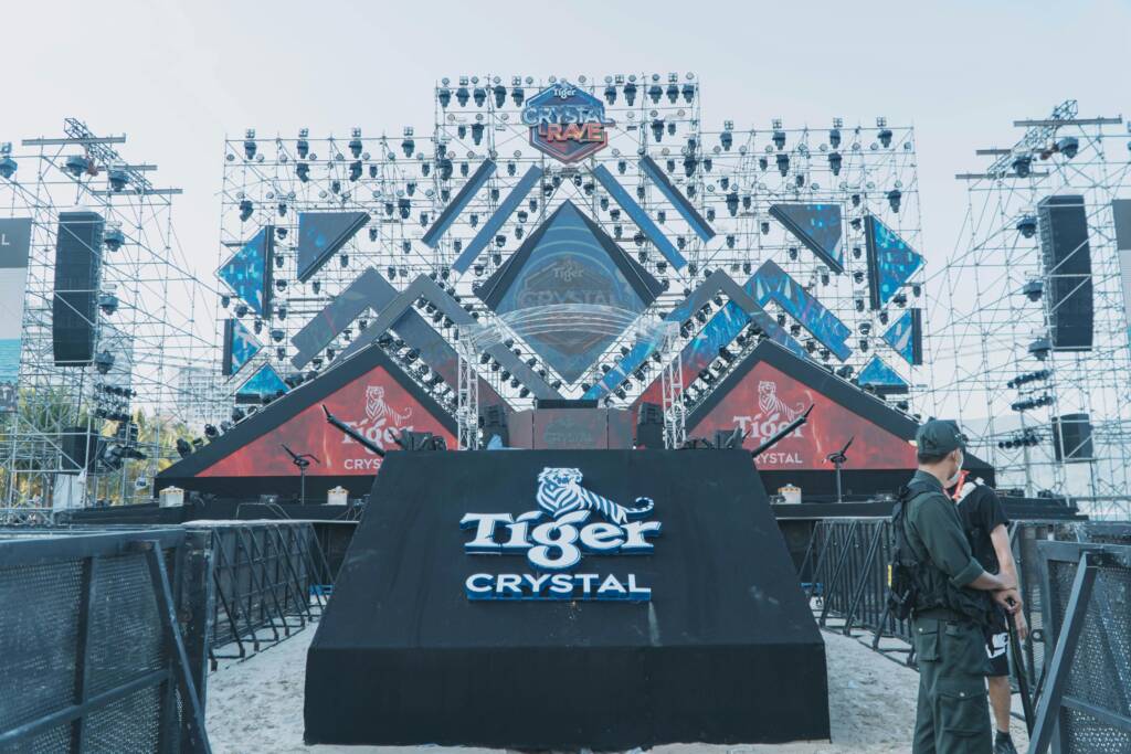 Outdoor stage setup for a major event featuring Tiger Crystal branding and structural lighting.
