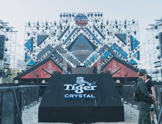 Outdoor stage setup for a major event featuring Tiger Crystal branding and structural lighting.